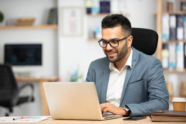 Professional studying on a laptop for the CESGS programme
